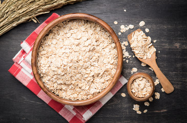 Sticker - Oatmeal or oat flakes on dark wooden table