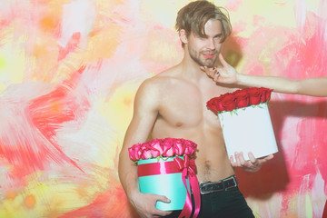 Canvas Print - bearded muscular man with sexy body holds red rose box