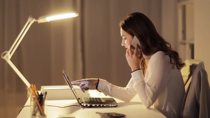 Canvas Print - woman with laptop calling on smartphone at office