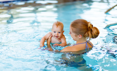 Wall Mural - Mother and baby swim  in pool