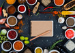 © Victor Lauer - Large set of spices, herbs, vegetables, notebook and pencil on black background