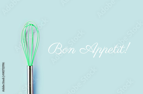 Neon green culinary whisk top view on colorful background Poster