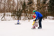 © RooM The Agency - Father teaching little daughter to skate in snow