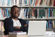 © Jale Ibrak - Happy African Male Student With Laptop In Library