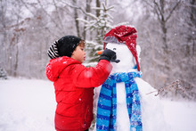 Boy Building A Snowman
