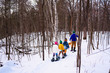 © RooM The Agency - Family snowshoeing with golden retriever dog