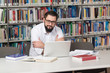 © Jale Ibrak - Happy Male Student With Laptop In Library