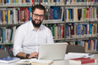 © Jale Ibrak - Happy Male Student With Laptop In Library