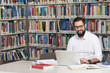 © Jale Ibrak - Young Student Using His Laptop In A Library