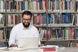 © Jale Ibrak - Happy Male Student With Laptop In Library
