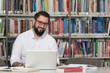 © Jale Ibrak - Happy Male Student With Laptop In Library