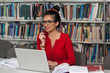 © Jale Ibrak - Happy Female Student With Laptop In Library