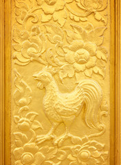 Canvas Print - Wood carved chicken and flowers painted gold adorned on temple door.