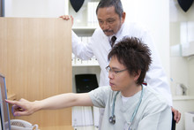 Two Male Doctors Examining X-ray