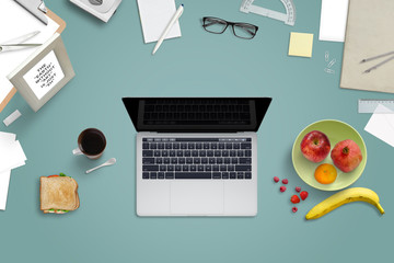 Poster - Laptop and food surrounded by office supplies. Hard work in the office and break with fresh fruit and a sandwich.Top view.
