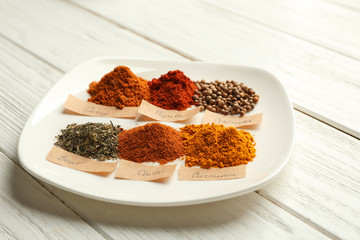 Wall Mural - Plate with mix of different spices on wooden table