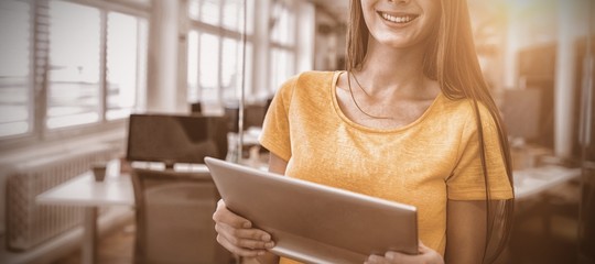 Poster - Female business executive using digital tablet