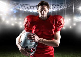 Canvas Print - Portrait of american player standing with helmet in stadium