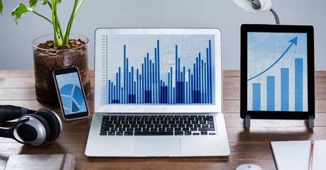 Poster - Digital tablet, mobile phone and laptop showing graph at desk