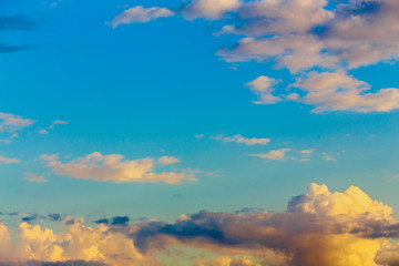 Wall Mural - Background, texture of blue sky with white, yellow, pink clouds