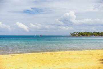 sea surf on the beach. Sand, sea, blue sky and white clouds