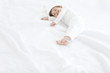 © amanaimages - Baby boy lying on duvet