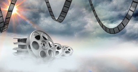Poster - film reels against sky in background