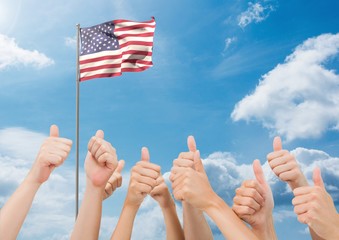 Wall Mural - American flag flapping in sky and hands showing thumbs up sign