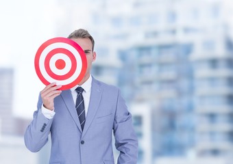 Wall Mural - Businessman holding target in front of face