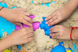 Leinwandbild Motiv Childs hand close up playing kinetic sand