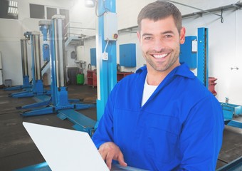 Wall Mural - Mechanic using laptop at workshop