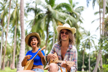 Wall Mural - Happy people playing music at palm trees background