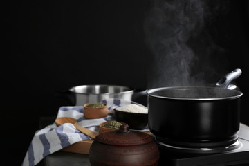 Wall Mural - Metal pan with steam on dark background