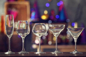 Poster - Different glassware on blurred background