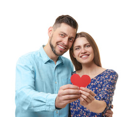 Poster - Happy young couple with red heart on white background