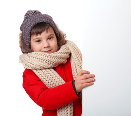 Wall Mural - Cute little boy in warm clothes with poster on white background