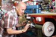 © JackF - Workman resharpening knives on machine.