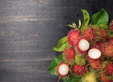 Fresh rambutan on dark wood with Text Space,top view