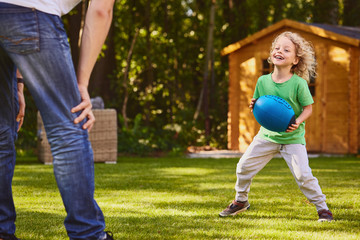 Wall Mural - Boy playing ball with father