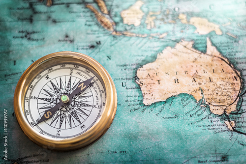 Old compass on vintage map. Retro style.