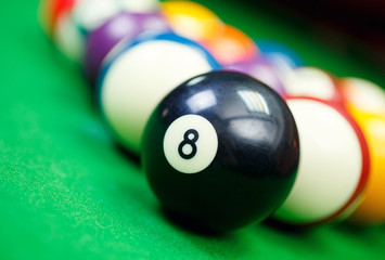 Wall Mural - billiard balls on a green pool table, closeup