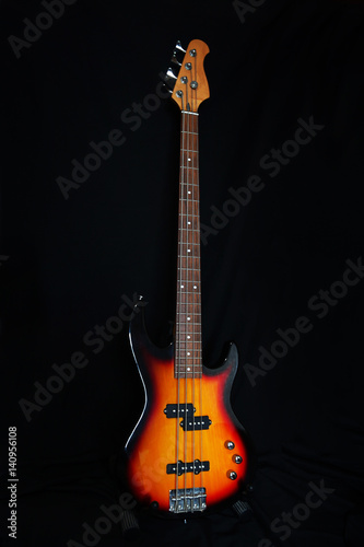 Obraz Dibond Bass guitar on a dark background