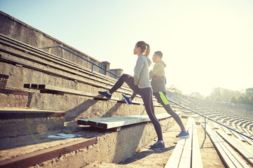 Wall Mural - couple stretching leg on stands of stadium