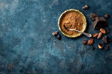 Wall Mural - Cocoa powder, beans and dark chocolate pieces crushed, culinary background, top view