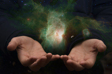 Wall Mural - The vast universe in the hands of a child. Elements of this image furnished by NASA.