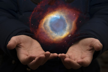Wall Mural - The vast universe in the hands of a child. Elements of this image furnished by NASA.