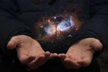 the vast universe in the hands of a child. elements of this image furnished by nasa.