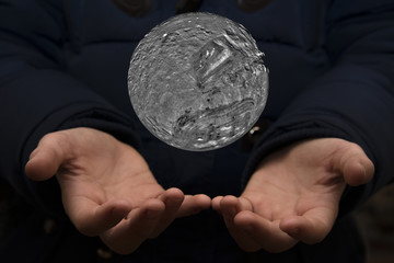 Wall Mural - The vast universe in the hands of a child. Elements of this image furnished by NASA.