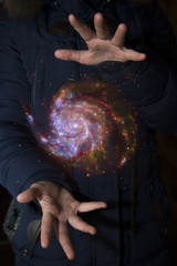 Wall Mural - The vast universe in the hands of a child. Elements of this image furnished by NASA.