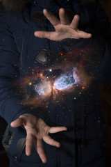 Wall Mural - The vast universe in the hands of a child. Elements of this image furnished by NASA.